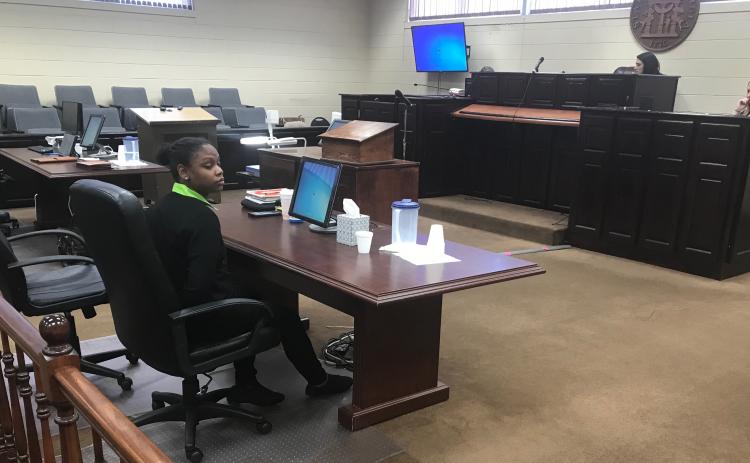 Savanna Marrie Jennings sits alone, handcuffed by Scott Franklin of the Elbert County Sheriff’s Office, shortly after a jury convicted her on seven charges, including malice murder and felony murder, in the death of Otha Perrin in 2018. She was also found guilty on two counts of aggravated assault, two counts of possession of a firearm or knife in the commission of a felony and concealing the death of another. (Photo by Jones)