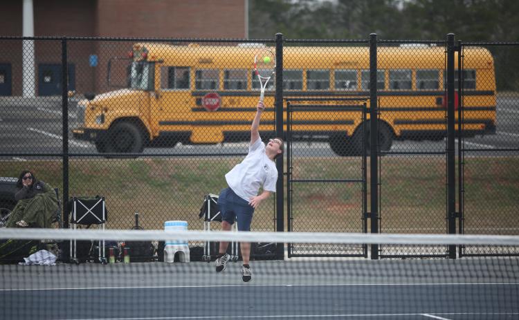Adrian Jenkins serves the ball during his 9-7 win over his Hart County opponent in the No. 1 singles match. (Photo by Wells)
