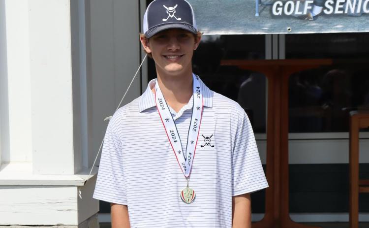 Devil golfer Landon Cagle poses with his first-place medal after finishing with the lowest individual score and being named low medalist of the Area 1A Division 1 championship match. (Photo courtesy of Larry Kesler)
